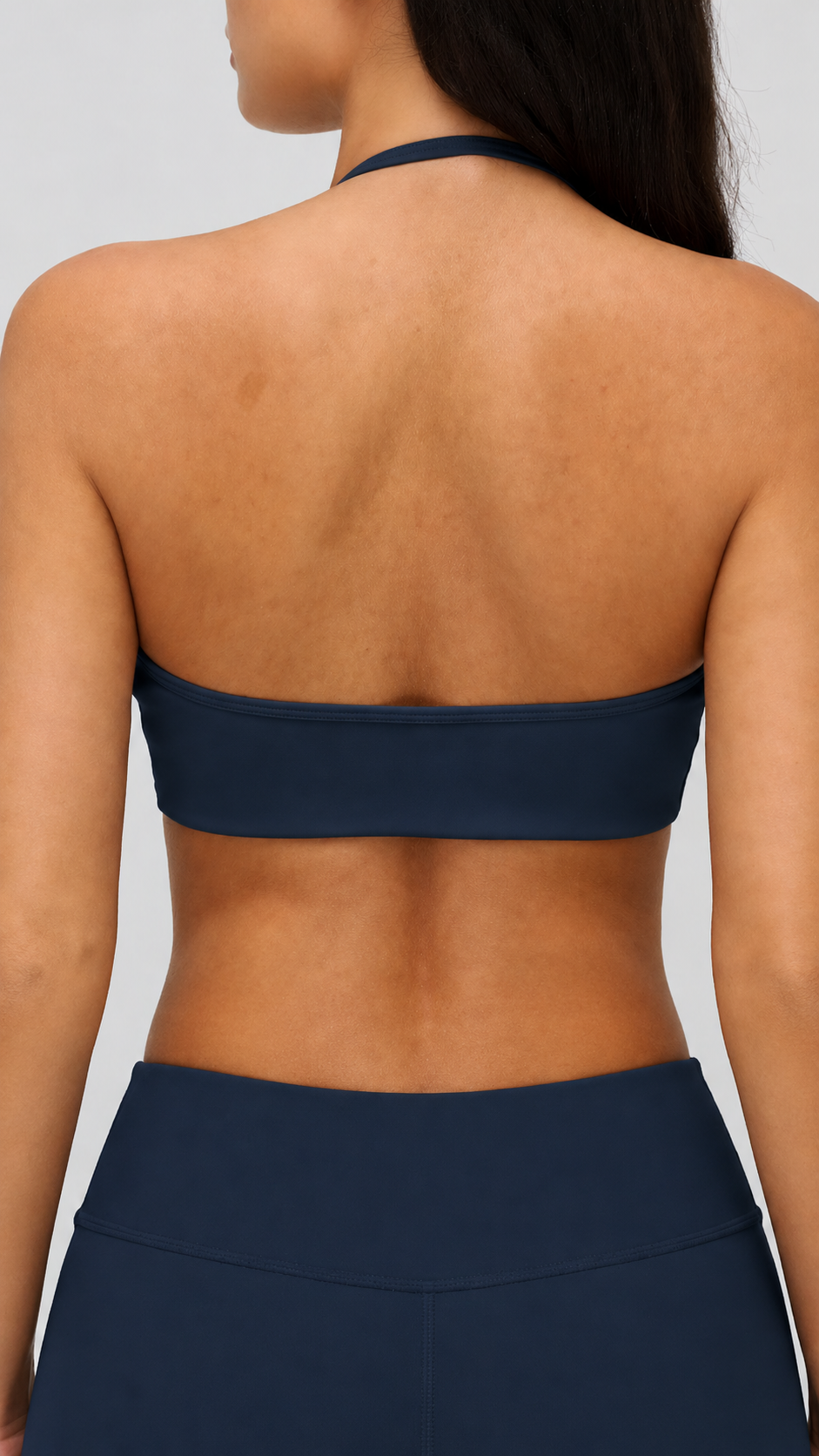 Navy blue bikini top worn by a model on a plain background
