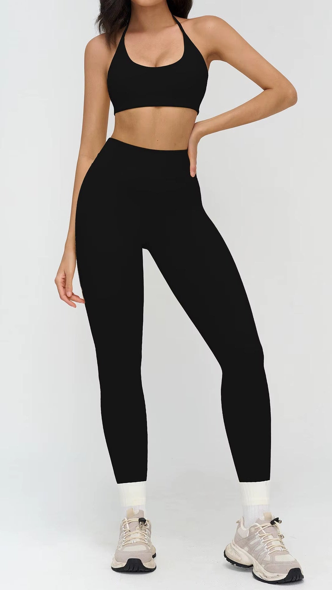 Person wearing a black athletic outfit on a white background